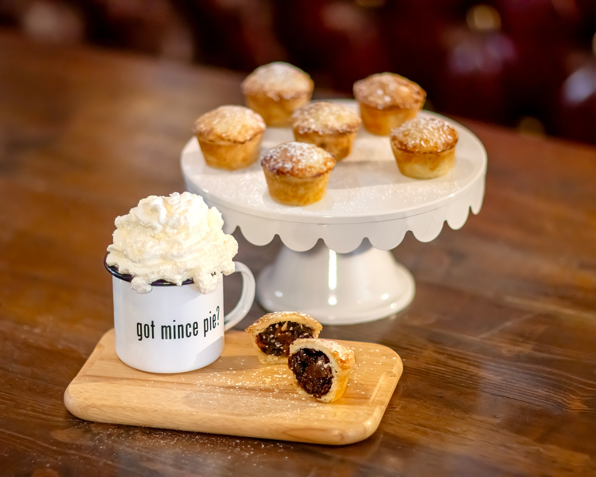 6 ready to eat mince pies with hot drink, one cut mince pie showing inside