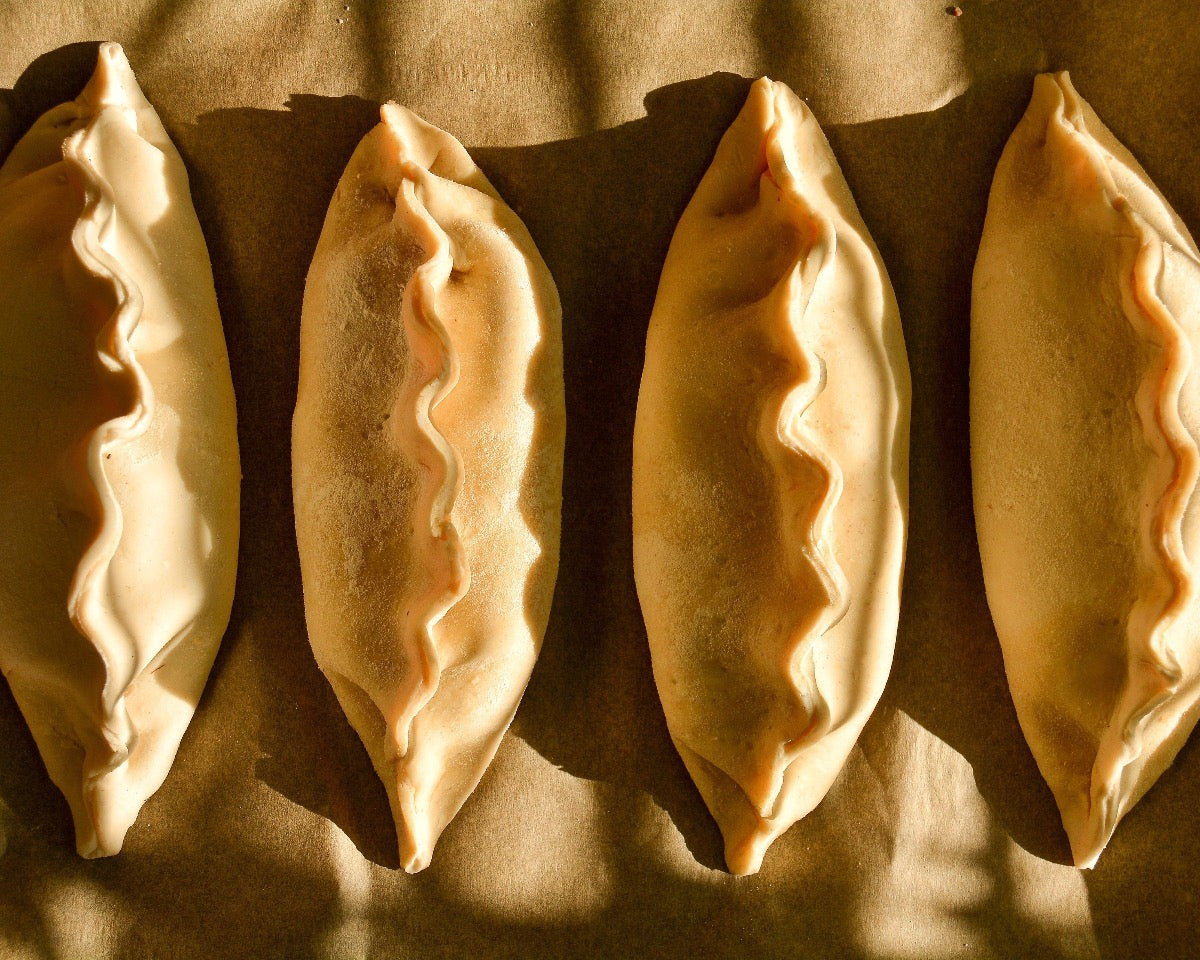 Four cheese and onion pasties packaged and ready for shipping