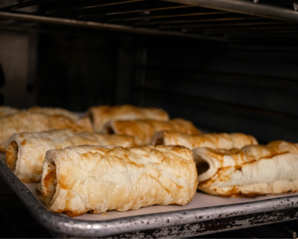 
                  
                    tray of warmed sausage rolls coming out of oven
                  
                