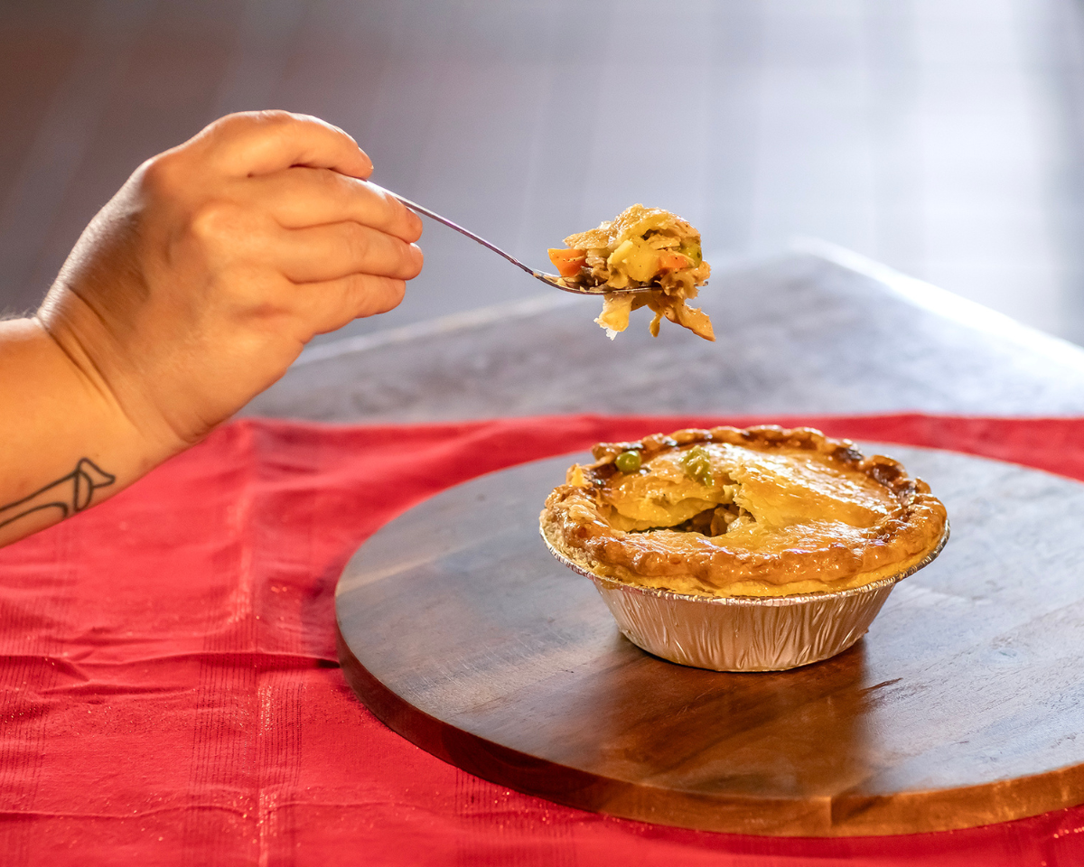 
                  
                    A golden creamy chicken pot pie with a fork full ready to eat
                  
                