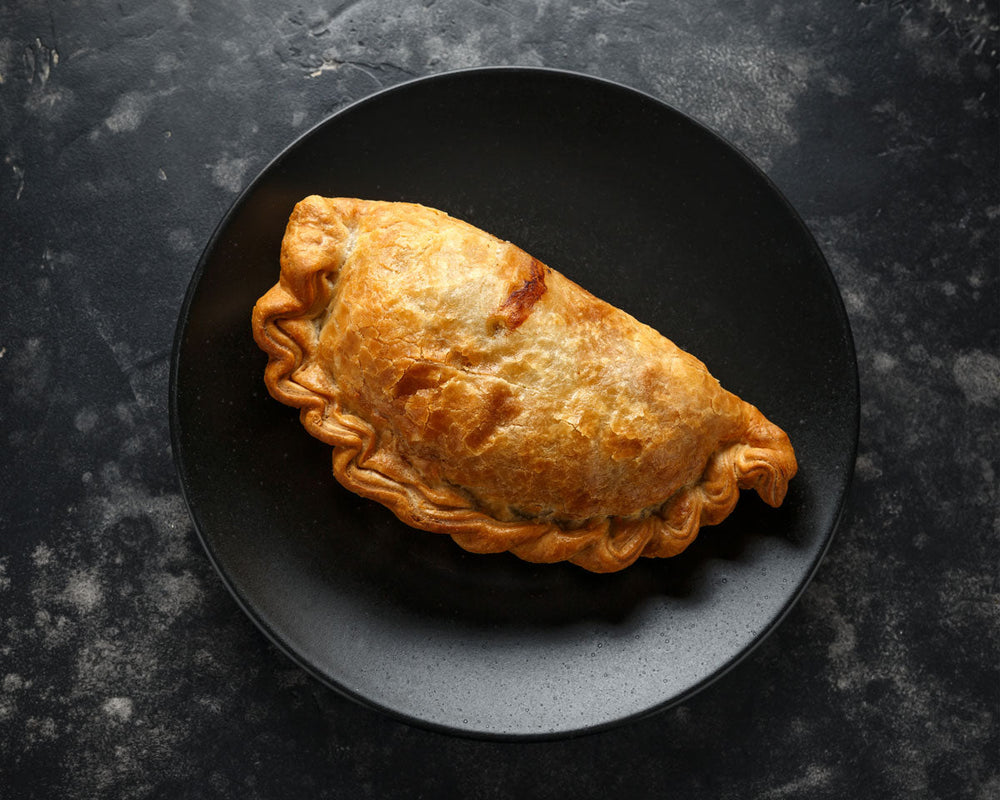 
                  
                    A golden beef Cornish pasty on a plate and ready for eating
                  
                
