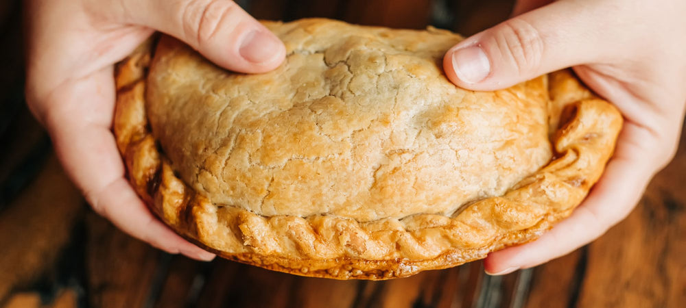 A woman holding an authentic, scratch-made Cornish pasty.