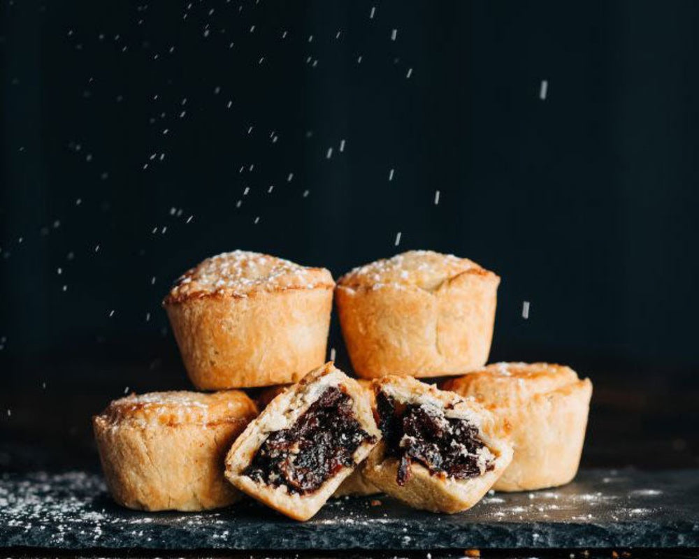 Mince pies, one broken open to reveal its delightfully boozy mince pie filling