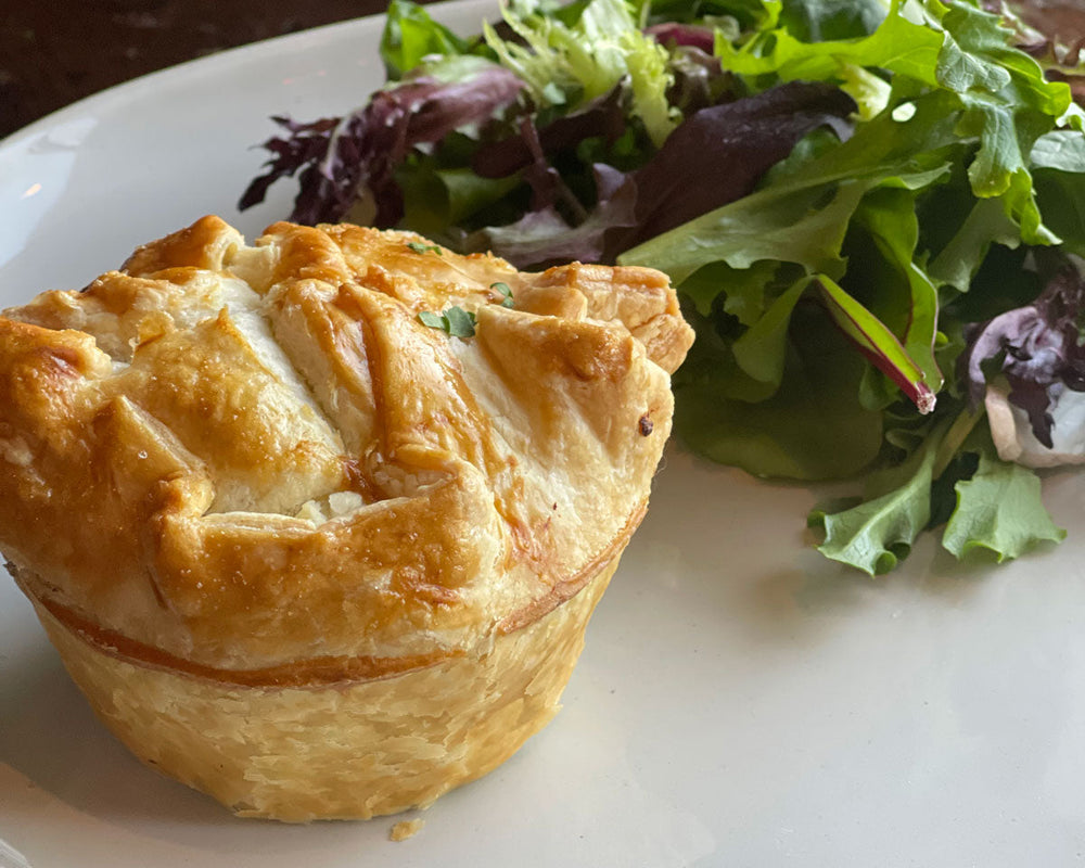 A golden SMaSH burger pie served with a mixed greens salad